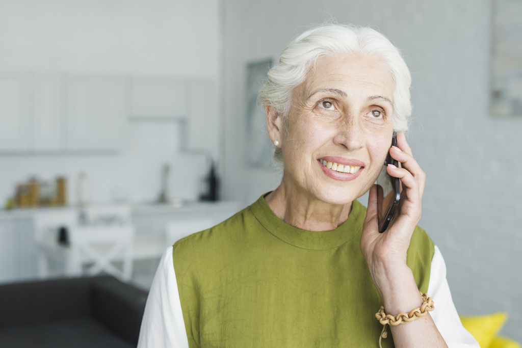 close-up-smiling-senior-woman-talking-cellphone.jpg